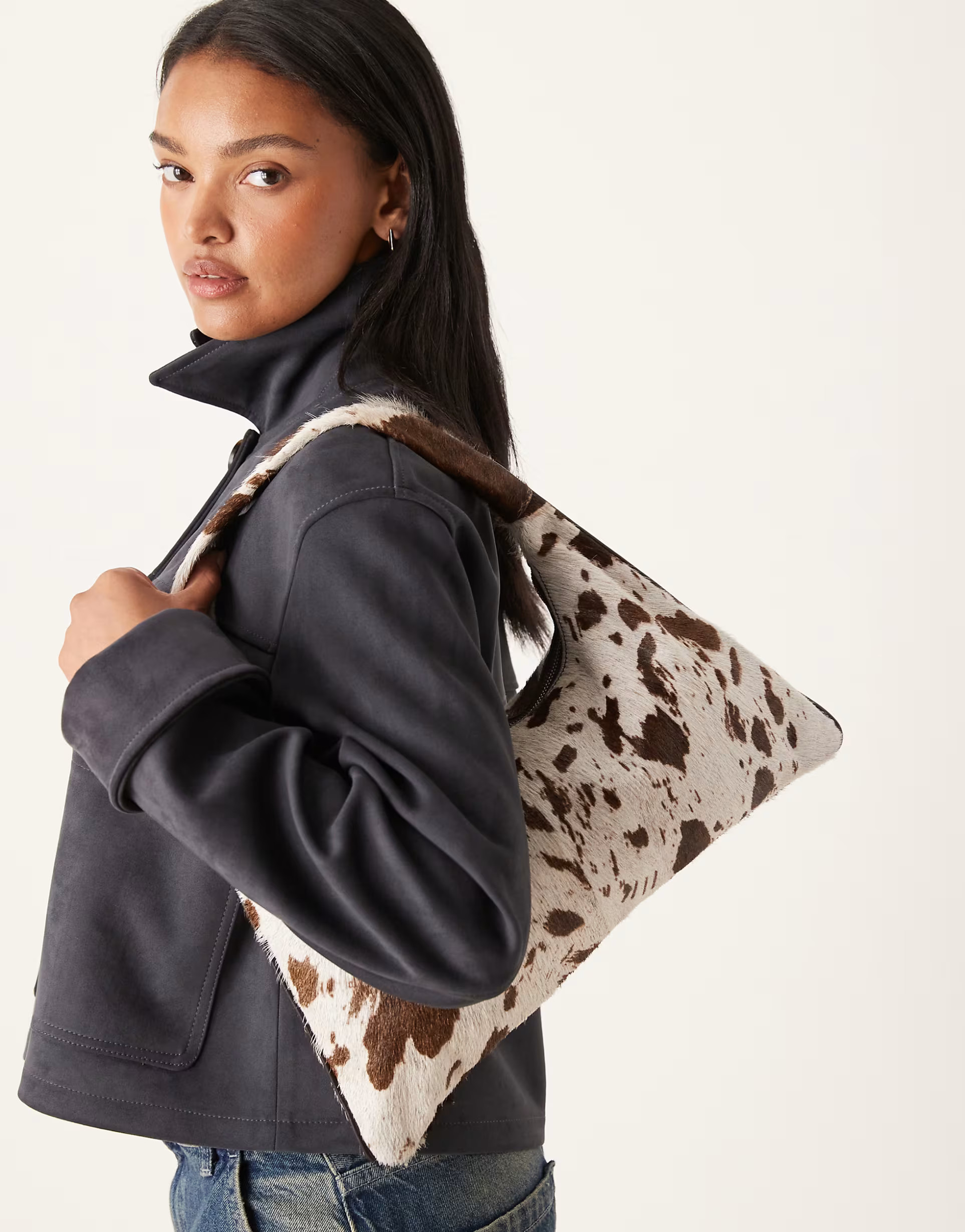 ASOS DESIGN pony hair trapeze shoulder bag in cow print | ASOS (Global)