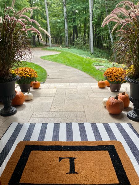 Create a beautiful Fall front porch! Layer outdoor area rugs with a coir monogram doormat. I love the marina stripes on this outdoor area rug because it’s super easy to clean and the doormat is heavy duty and fits perfectly in front of the front door. Fill your outdoor pots with mums and add pumpkins to complete an inviting Fall entryway. 
#kimbentley, front porch, entryway, fall decor

#LTKHalloween #LTKhome #LTKover40