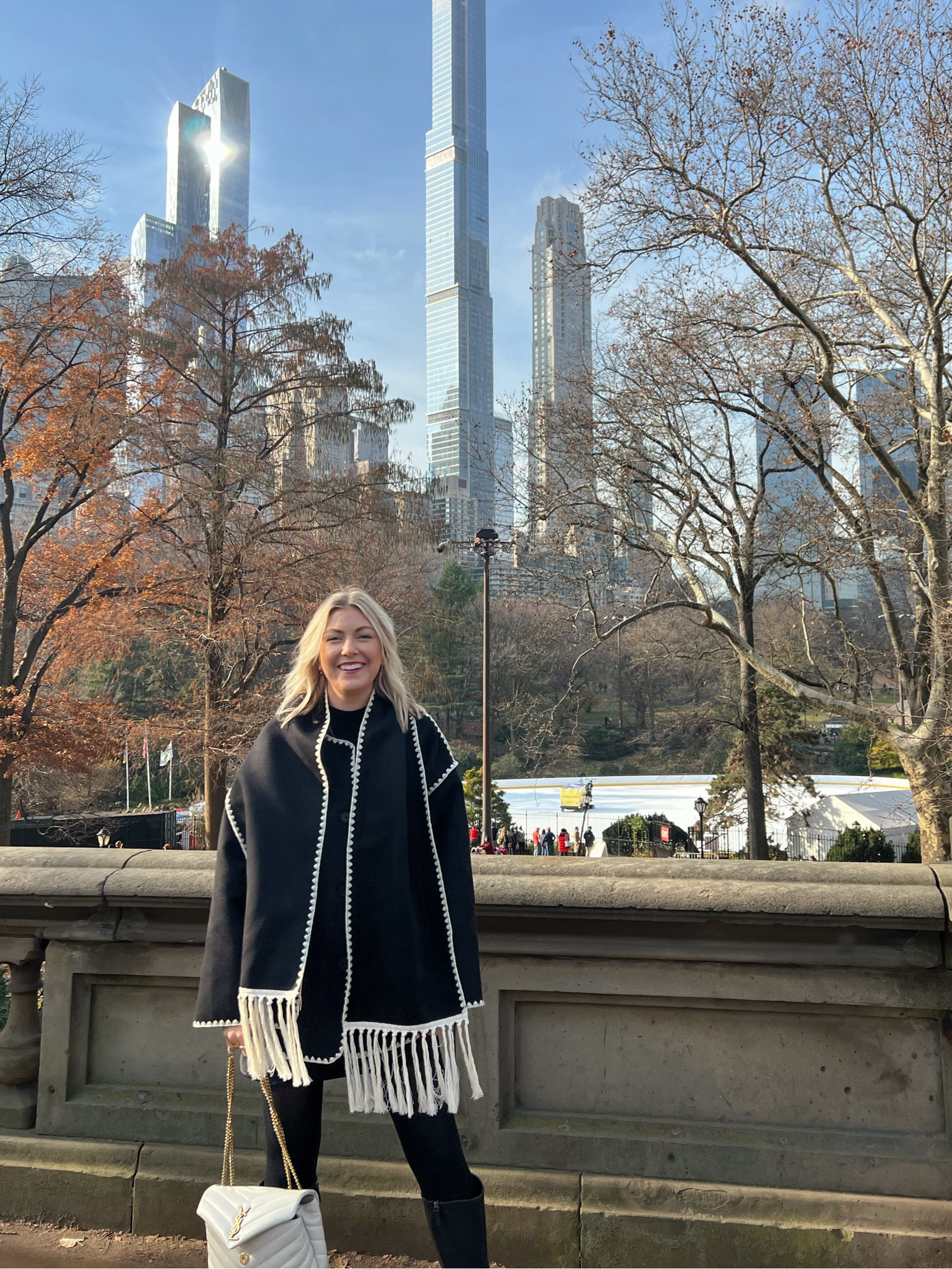 Wearing a cute black & white scarf jacket (toteme dupe) with boots, tights, and a cream pursee

#LTKSeasonal #LTKstyletip