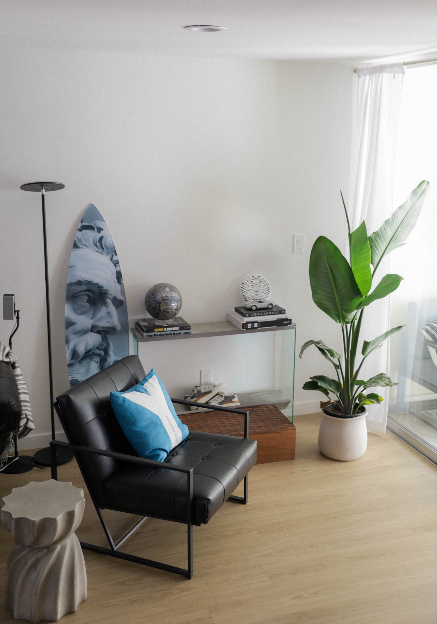 My favorite corner of the living room:

Modern chair, side/console table, plant, and decorative art pieces  

#LTKSeasonal #LTKhome #LTKmens