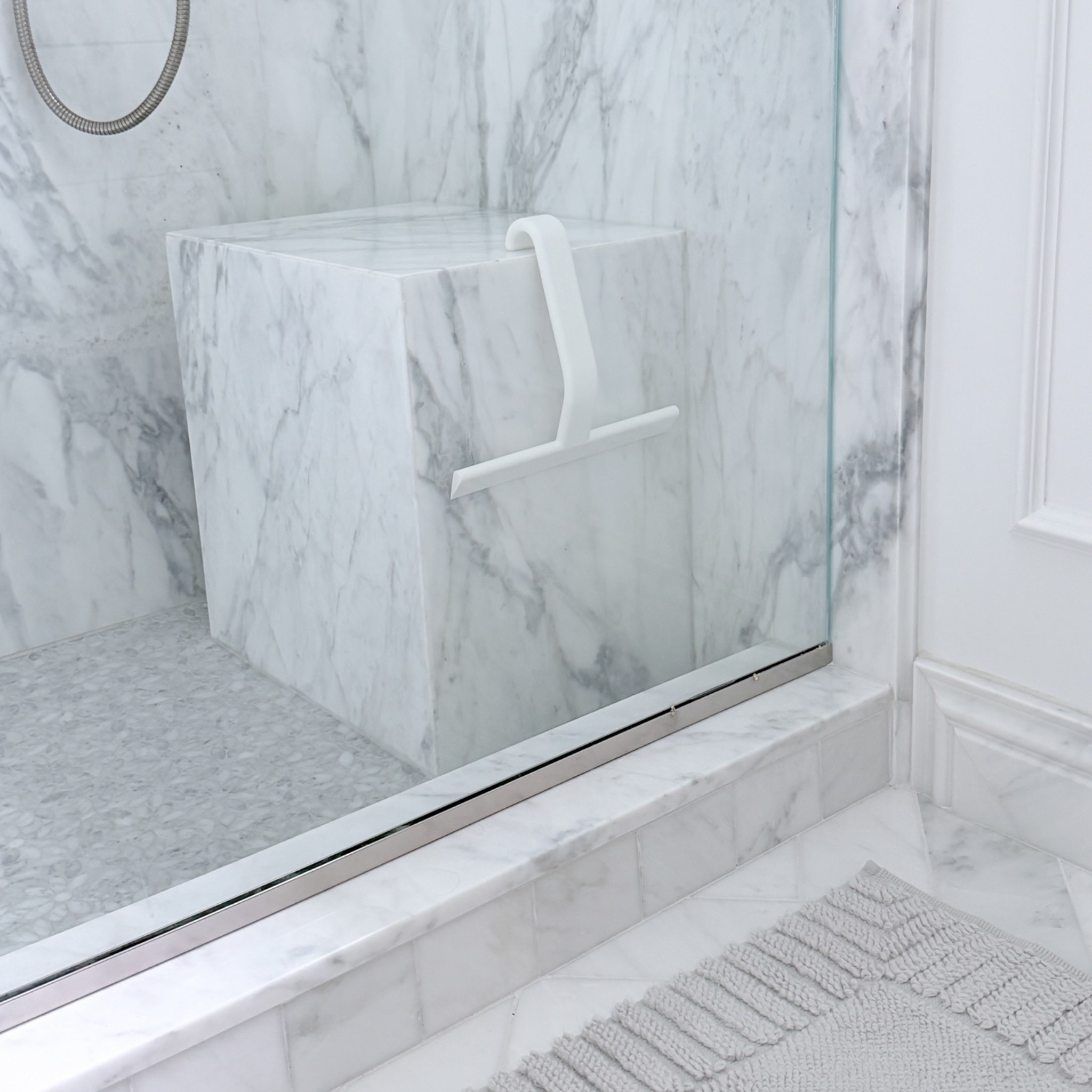 One of my only bathroom design mistakes was buying the wrong squeegee. I originally had one with a metal handle and it would bump into the walls, door handle and glass when doing the corners. I swapped to this simplistic white one that’s made of 100% silicone & it makes it so much easier since the squeegee won’t damage or chip any of the marble if I’m cleaning too quickly and bump into the edges. I also love that the handle is ergonomic & also is designed in a way to hang from the bench or the top of glass, I usually keep it on the other side of the bench so it almost completely disappears into my white marble shower, but is still within reach & easy to grab.

#LTKdayinmylife #LTKHome #LTKSaleAlert