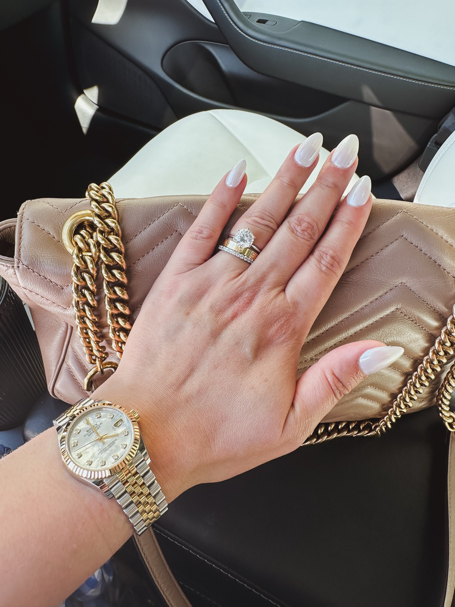 { Love a combination of pearl white nails, Gucci bag, white Tesla interior, and a mixed metal Rolex 🤍🤍🤍 }