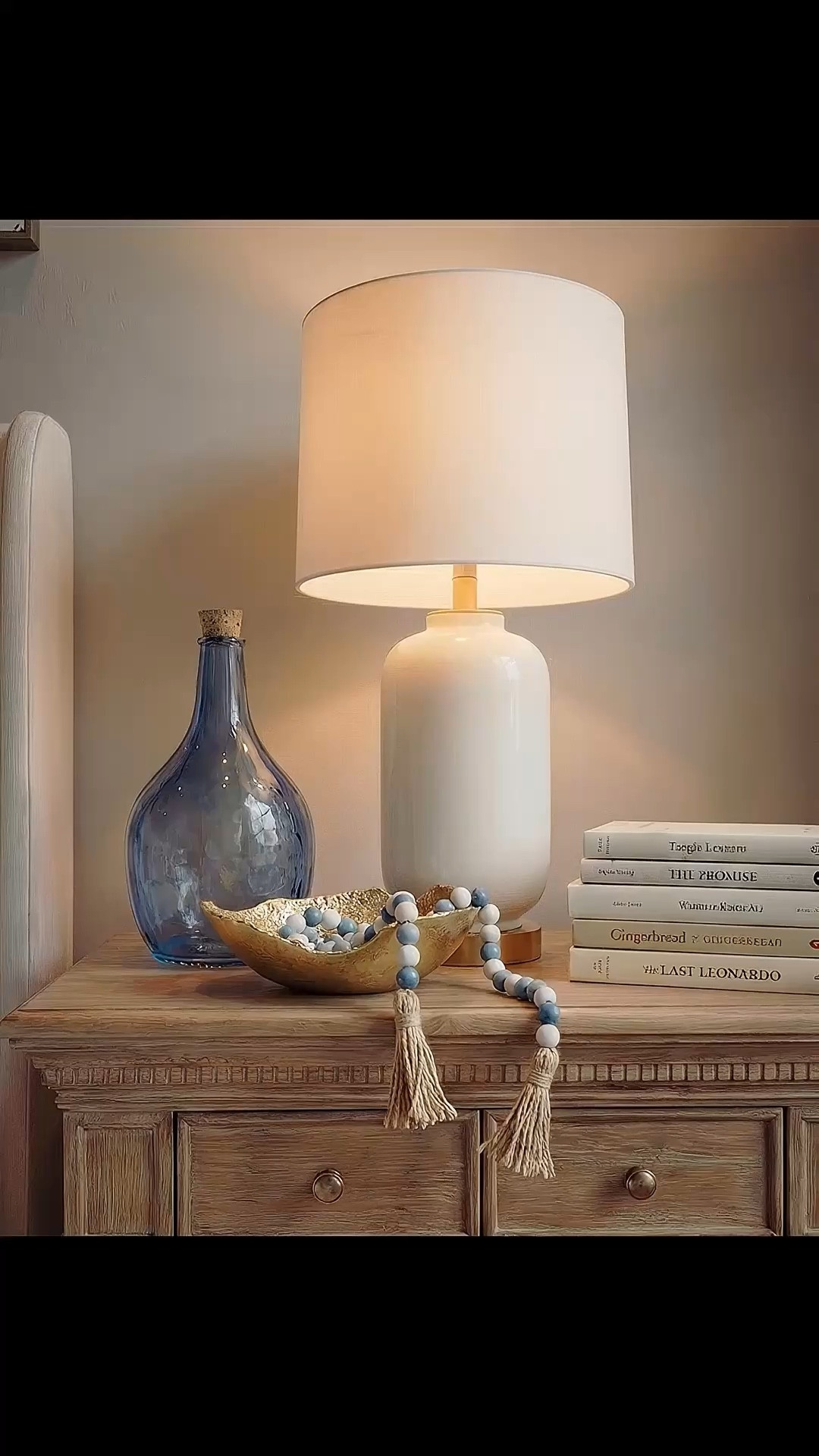 Shop the Look: Bedroom Refresh
• Upholstered bed frame (soft ivory fabric)
• Neutral bedding set (white and light beige)
• Brown throw blanket (plush or wool)
• Blue and ivory accent pillow
• Wood nightstands with drawers (warm oak tone)
• Ceramic table lamps (white base, white shade)
• Blue glass decorative vases
• Framed blue-and-white botanical wall art (set of three)
• Upholstered bench with fluted wood base
• Traditional patterned area rug (beige, taupe, muted blue)
• Floor-length neutral curtains
• Wood ceiling beams (natural stained finish)
• Brass decor bowl all catch
• White and blue decor beads 

#LTKHome #LTKSaleAlert