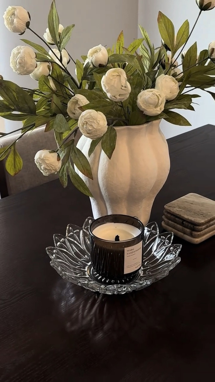 Some dining table inspiration for you!! 🤍

I absolutely love this little glass bowl as a base for a candle. Found her at an antique store!! 

A pretty textured vase with realistic florals adds the perfect focal point. You can even get greenery that’s a tad more drapey, so it doesn’t obstruct any views. And add a stone coaster stack for some added dimension and texture 🫶🏼 
Glass + ceramic + stone/marble might be my new fave mix! 

#homedecor #kitchendecor #interiordesign

#LTKHome