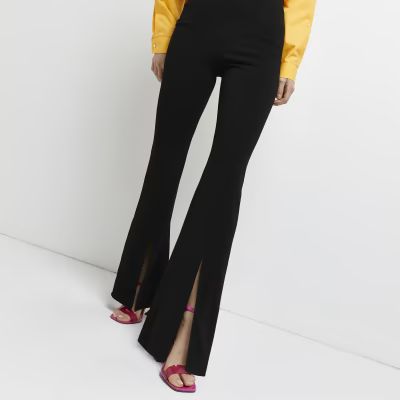 Black split front flared trousers | River Island (UK & IE)