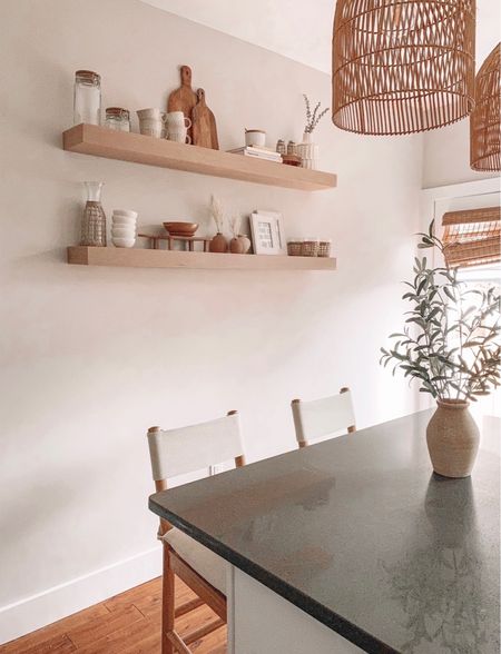 Adding these floating shelves to our kitchen really helped to elevate this blank wall. We also love your affordable neutral kitchen stools and the warmth and texture brought in by the rattan pendants. 

#LTKhome