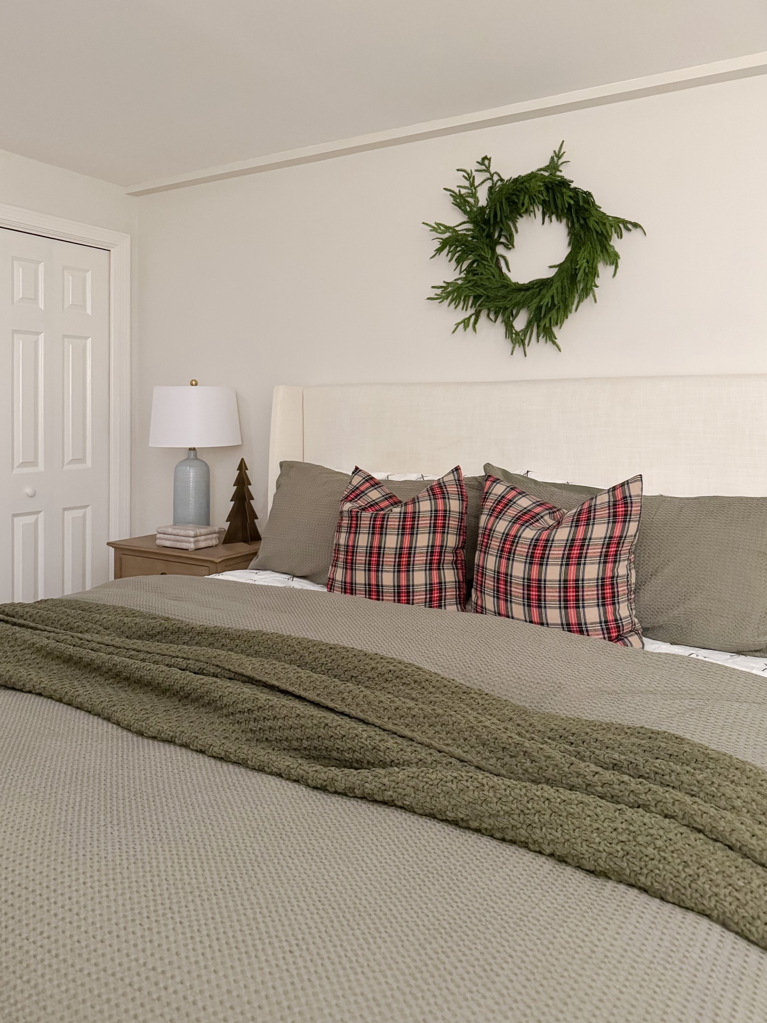 A simple and charming winter bedroom nightstand with a tiny evergreen, vintage clock, and ceramic accents. This styling keeps the guest space festive without feeling heavy or cluttered. winter bedroom, guest bedroom decor, coastal bedroom style, holiday nightstand, neutral winter decor, bedside styling, cozy guest room, coastal winter bedroom, seasonal accents, soft neutral styling, Sherri Calnan Home

#LTKHome #LTKHoliday