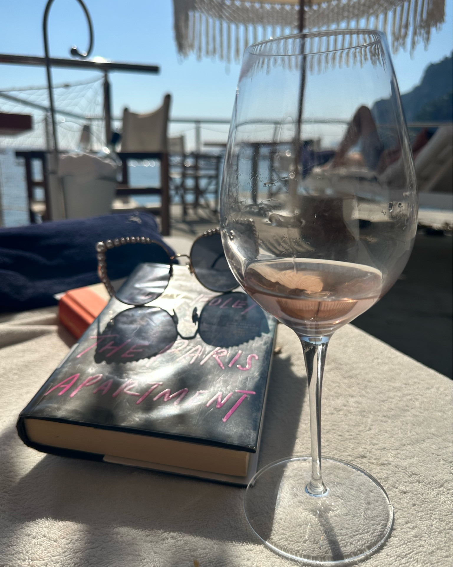 Vacation essentials— a good book, sunglasses, and a glass of rosé.

#LTKtravel #LTKeurope