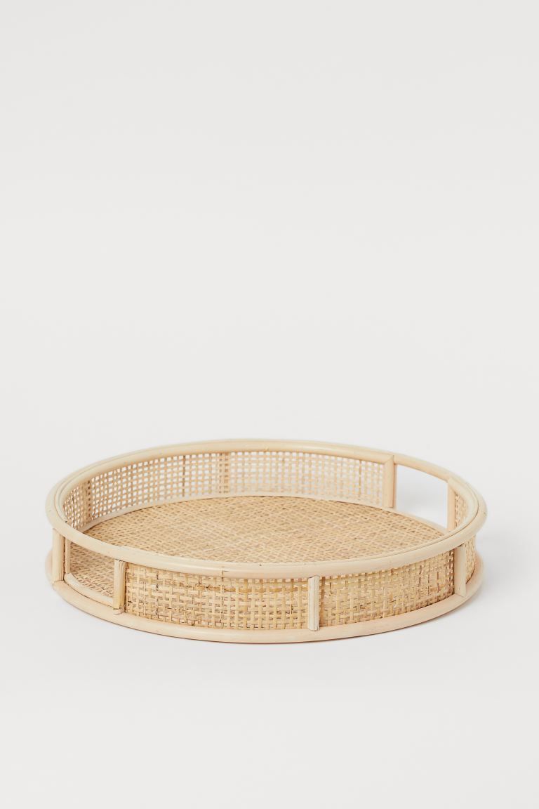 Round tray in braided rattan with handles at sides and a high rim. Height 2 1/4 in. Diameter 14 i... | H&M (US + CA)
