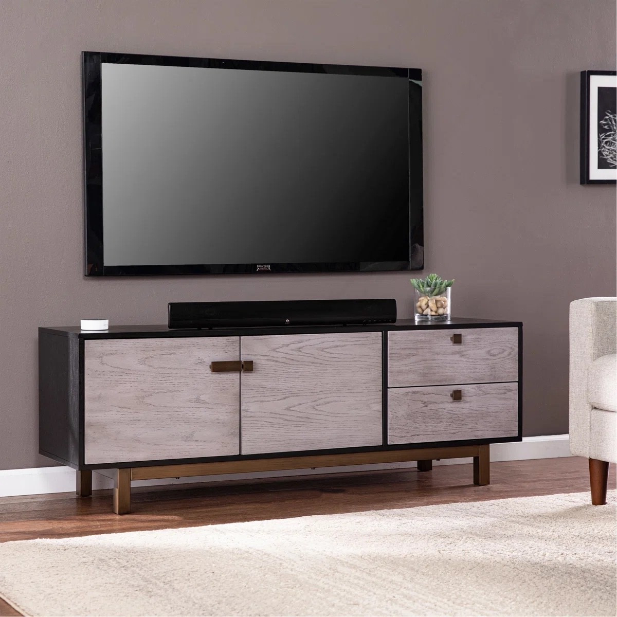 This low profile media console from Wayfair is such a sleek upgrade for a modern living room. The two tone wood finish, clean lines, and spacious storage drawers keep your entertainment area looking organized and elevated. Perfect under a wall mounted TV with a soundbar and simple decor styling.