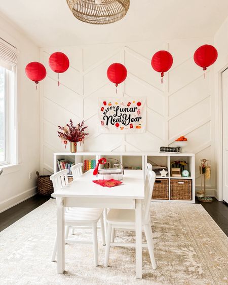 Lunar New Year Decor with paper red lanterns, hanging pendants, brass vase, Chinese new year decorations, craft table, wooden chairs, rug! 

#LTKfamily #LTKbaby #LTKhome