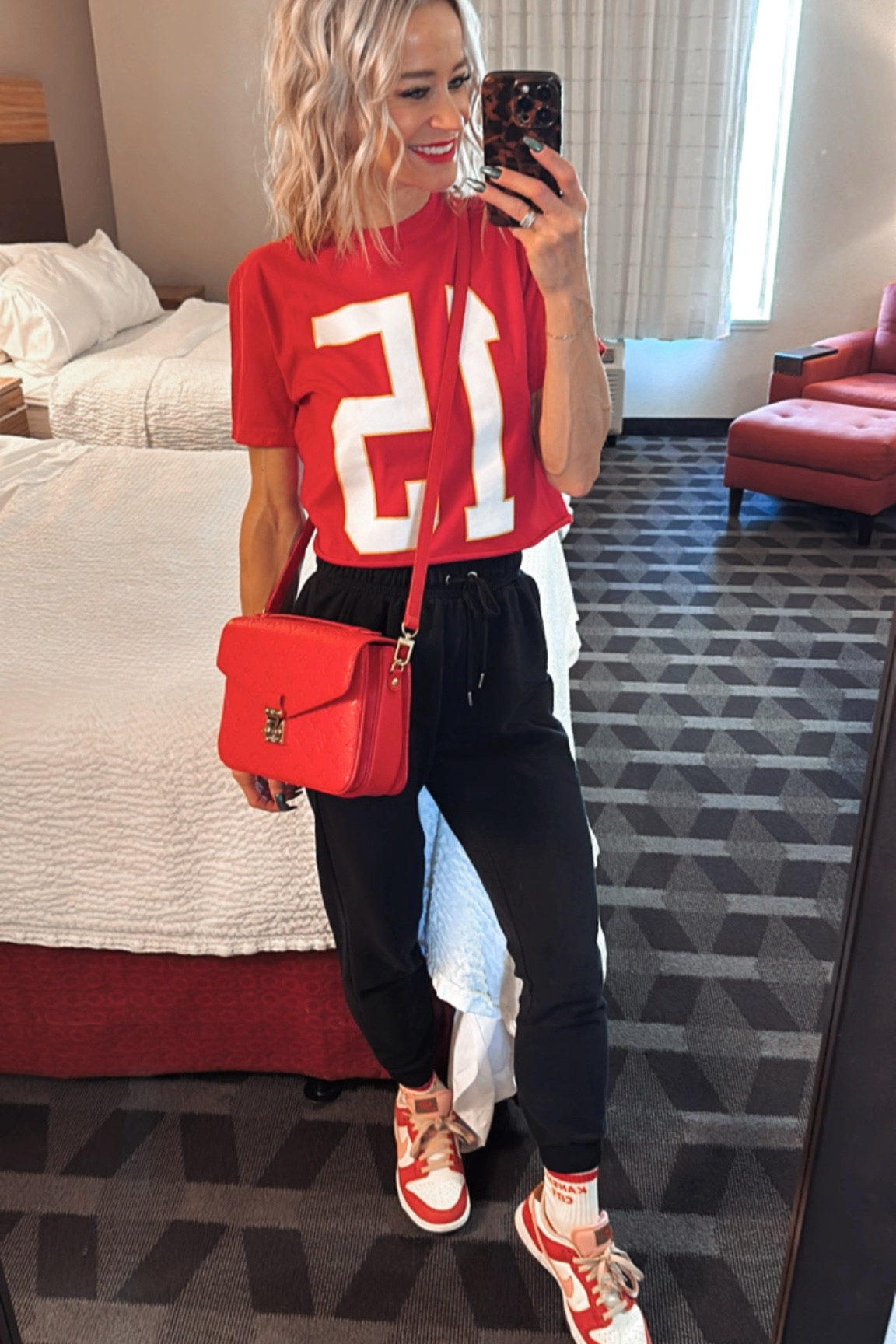 Chiiiiiefs red in the house❣️

Cutest little bright red purse and perfect for those game days, Christmas, Valentines Day, or 4th of July. 
LOVE these Nike Dunk Low PRM women’s in Bacon color. They go with SO much stuff and I get compliments on them all the time. 

This Patrick Mahomes 15 Kansas City Chiefs crop is 1KC brand and available at madeinkc.co It’s not too cropped and says KANSAS CITY on the back. 

Cute Kansas City socks are Carly Rae brand and also available at madeinkc.co 

#LTKSeasonal #LTKstyletip #LTKfindsunder50