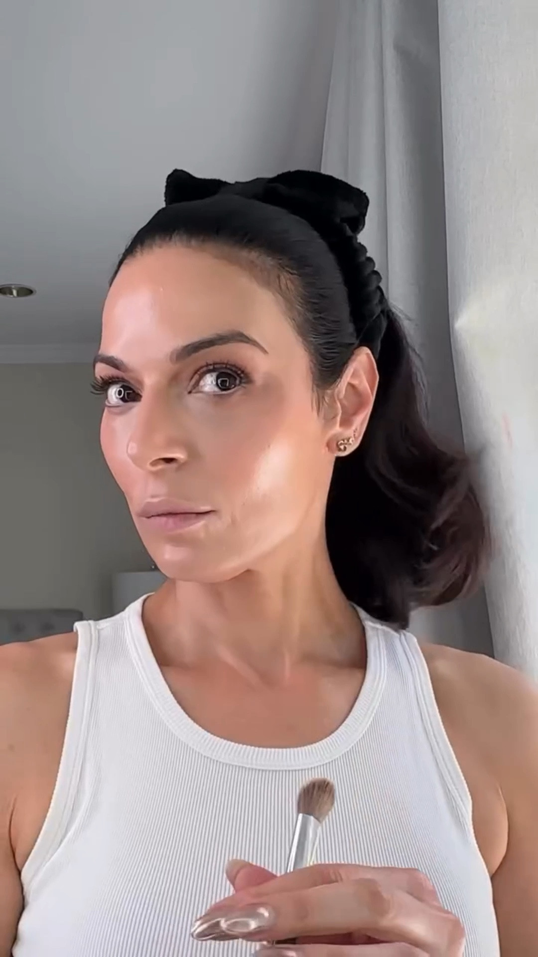 Basics of my base. 

It really starts with great skincare… but that’s another reel. 

How I did it: 

 @itcosmetics Bye bye undereye - color correction using a deep tan shade and then I contour and carve out my features 

@saiebeauty Dew Blush in Sweetie applied above cheekbones to my temples for a lifting effect 

@lorealparis Lumi Glotion applied over top my blush for a luminous lit from within look 

@armanibeauty Luminous Silk Concealer for under eye brightness and lift at the inner and outer corners and under my lips to counter the shadow from the downturn (thank you maturing skin). 

@diorbeauty Foundation Stick helps blend this all seamlessly. I make sure to not over the blush but just hit the edges for a cohesive look. 

Pro tip: I use my damp blender between each step to keep it looking sheer and dewy. 

@hudabeauty powder to set the undereyes and everyday I move that tends to crease, like my smile lines because I’m always smiling. 

Of course, I add a little more blush, some gloss and that’s the look! 

I’ll show you my eye makeup in a future reel.

Let me know what else I can help you with.