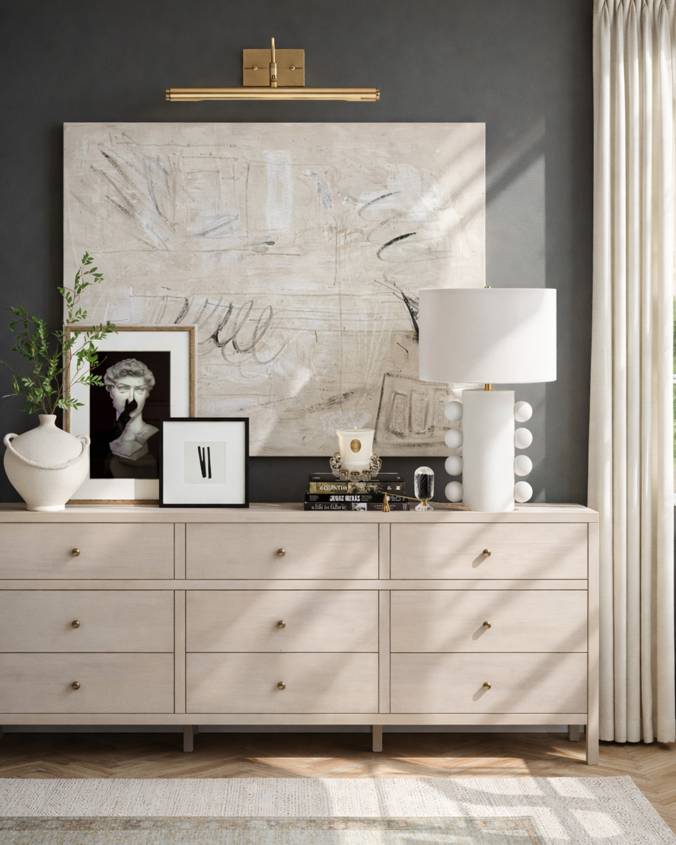 If your bedroom feels unfinished, chances are your dresser is doing nothing for the space.

This setup shows how to turn a basic dresser into a designer moment with just a few intentional pieces:
✔️ Oversized art for scale
✔️ A picture light for warmth
✔️ Mixed frames for contrast
✔️ Sculptural decor for texture
✔️ Soft lighting to elevate everything

The result? A calm, curated look that feels collected — not cluttered.

This is how you get that “luxury home” feeling without a full renovation. Save this for your next refresh ✨ 

 #LTKHome