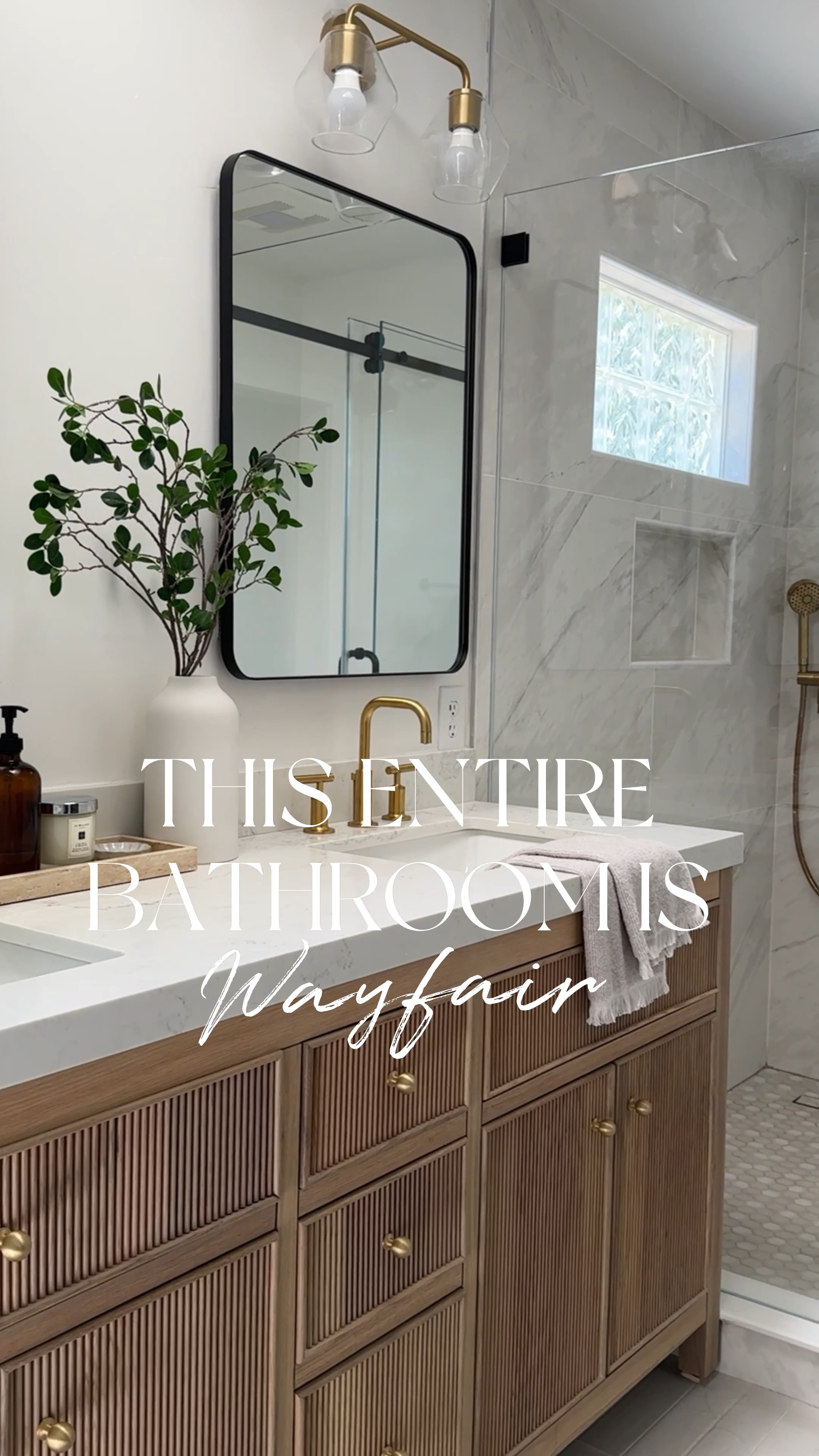 This entire beautiful bathroom is from @Wayfair. We used so many affordable options, yet were able to achieve this high-end look. Love the reeded detail of this prefab wood vanity, which comes with multiple different countertop options. My favorite part could be the medicine cabinet. So stylish and functional. Love how the neutral colors of the tile provide a serene vibe.

Marble tile, large format, tile, gray tile, wood, vanity, brass faucet, brass shower system, black rectangle, mirror, medicine cabinet glass, sconces, brass, sconces, glass, shower door, sliding glass door

#Ad,
#WayfairPartner, #PaidLink #wayfair

#LTKHome #LTKSaleAlert #LTKFindsUnder100