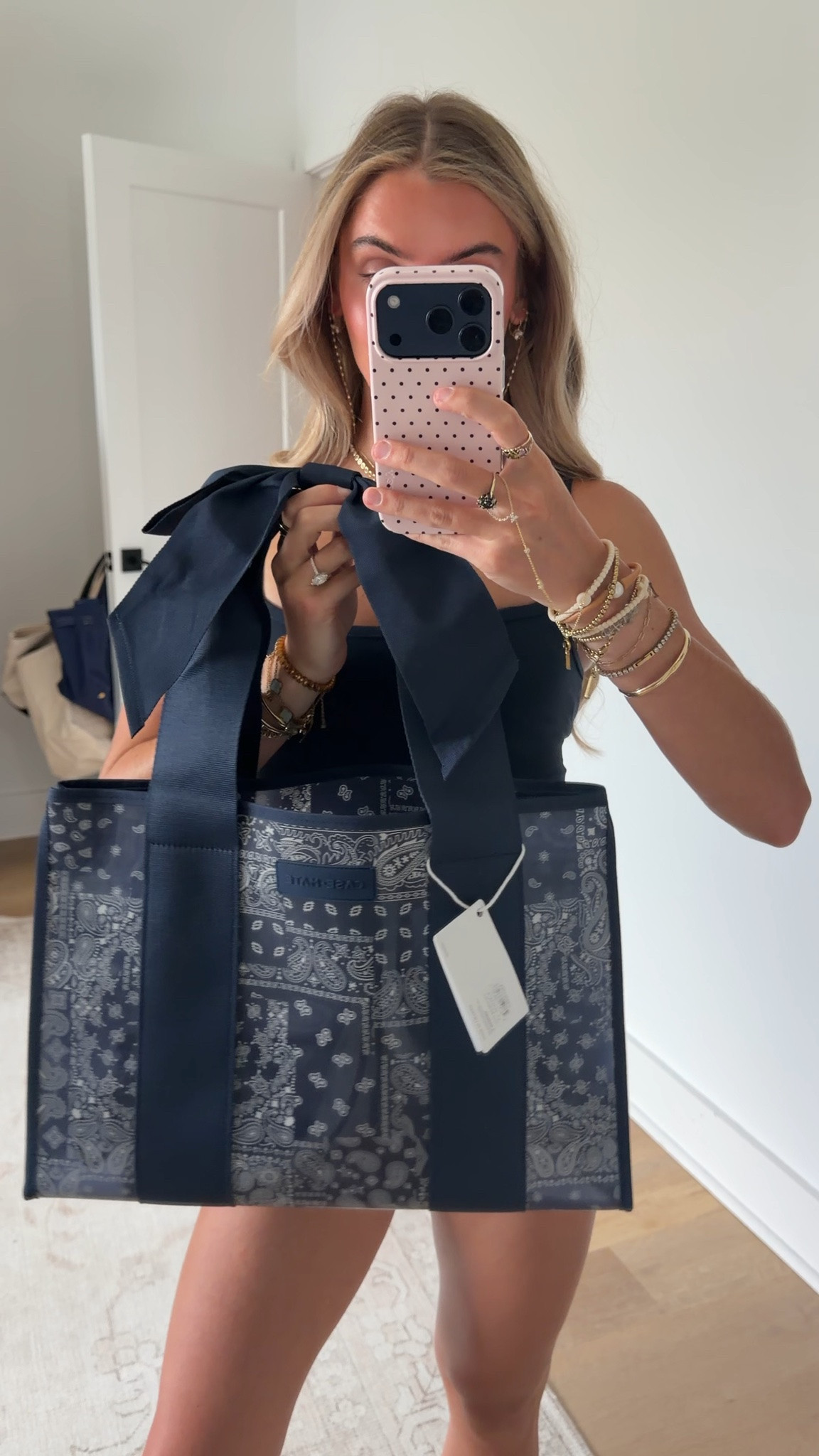 The Navy Bandana Bow Jelly Tote channels the effortless cool of an open road and wide-open skies with its Americana-inspired paisley print and oversized bow. Spacious yet lightweight, this bag is perfect for everything from errands and workdays to beach trips and travel. Fold it flat when you need a little more room in your suitcase, use it as your carry-on, or fill it with your daily essentials. This large tote bag is made from jelly-like TPU material that’s waterproof, wipes clean with ease, and holds up over time. The extra-wide jacquard straps and a covered snap closure make even a fully packed bag comfortable to carry. Inside, you’ll find a small zipper pouch and key leash to keep your phone, wallet, and daily essentials organized and always within reach. Fold it or fill it, this tote bag is ready for wherever you go! @case-mate

#LTKootd #LTKSwim #LTKTravel