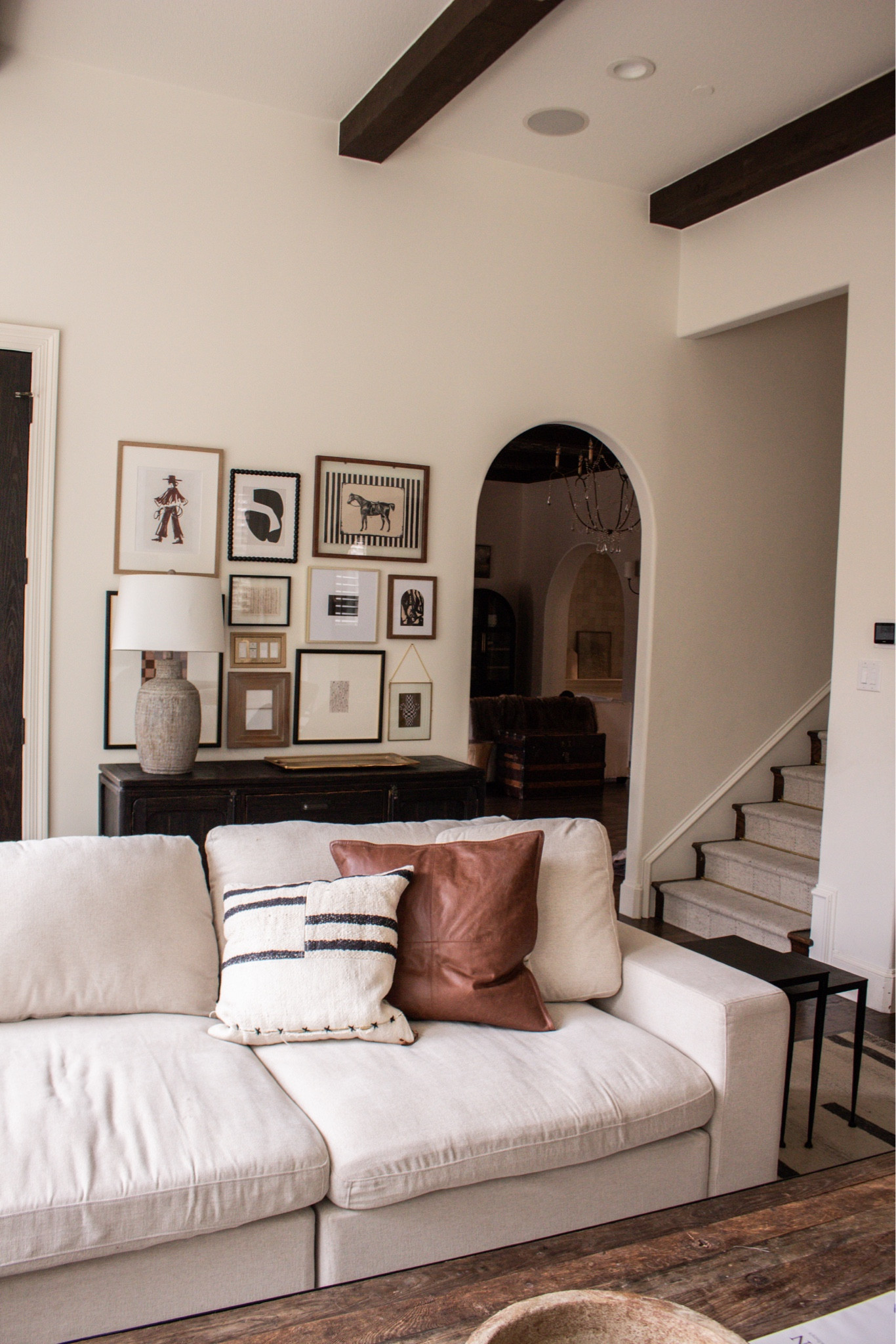 Neutral living room inspiration with dark wood beams, oversized sectional, leather chairs, and a modern crystal chandelier. Transitional home decor, elevated cozy space.

#LTKHome #LTKSeasonal