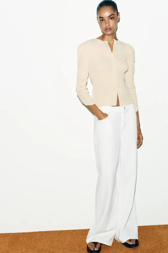 Round neck cardigan with puff sleeves and an asymmetrical finish. Front fastening with covered bu... | Zara UK