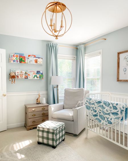 Sweet baby boy nursery on a budget! 
Things not linked: IKEA drapes, vintage chest, wood frame. 
Linked: love our pottery barn rocker, the green gingham ottoman adds a fun pop. French return brass rods prevent light leak. Charming brass chandelier and sweet Etsy art  

#LTKstyletip #LTKhome #LTKfindsunder100