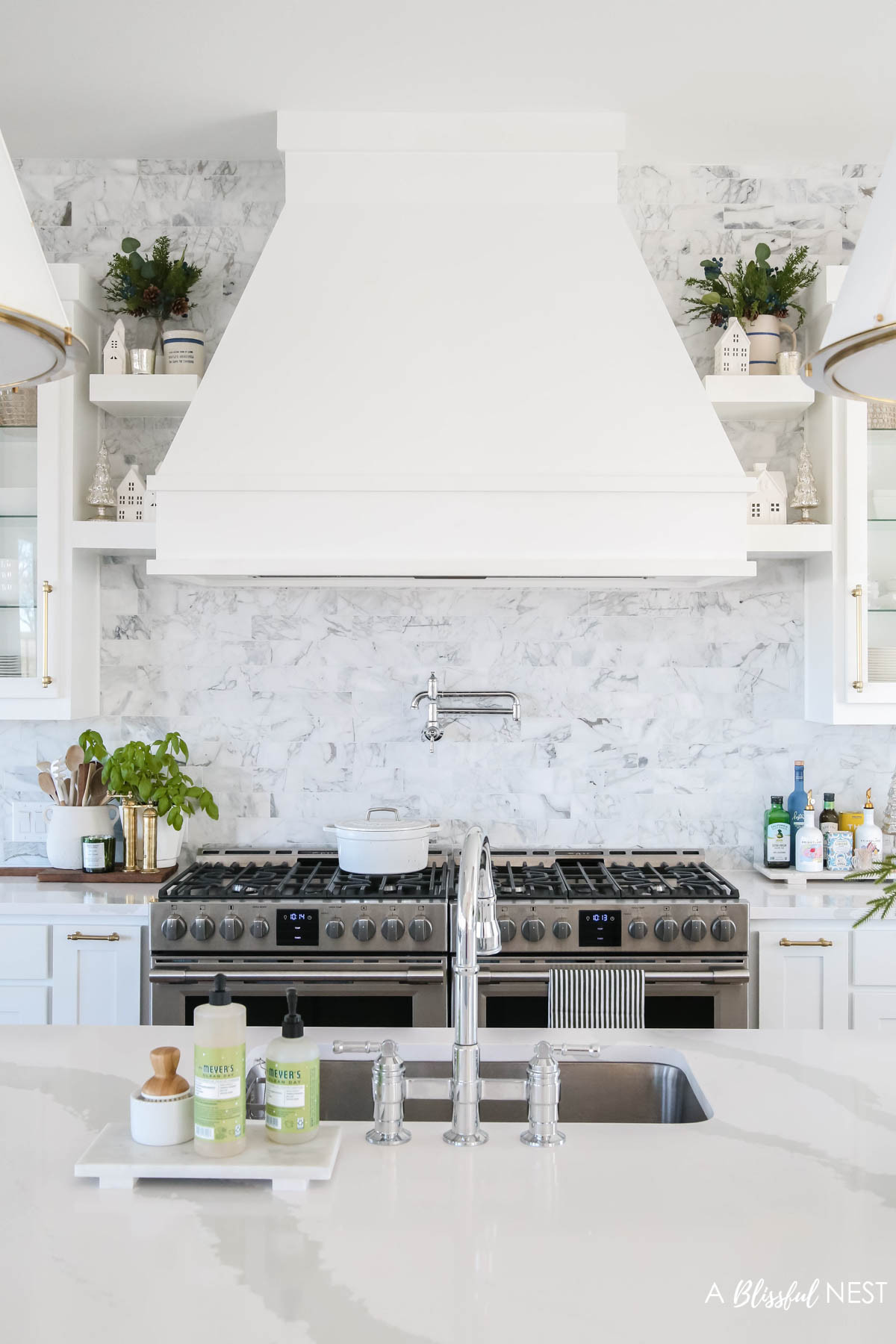 A clean Christmas kitchen with just the right festive touch. Snag the decor I used here.
wooden spoons, bamboo dish scrub brushes, Mrs. Meyer's kitchen set, European mill, Thymes Frasier Fir candle, Mud Pie utensil holder, Christmas village houses 

 #LTKHoliday #LTKSeasonal #LTKHome