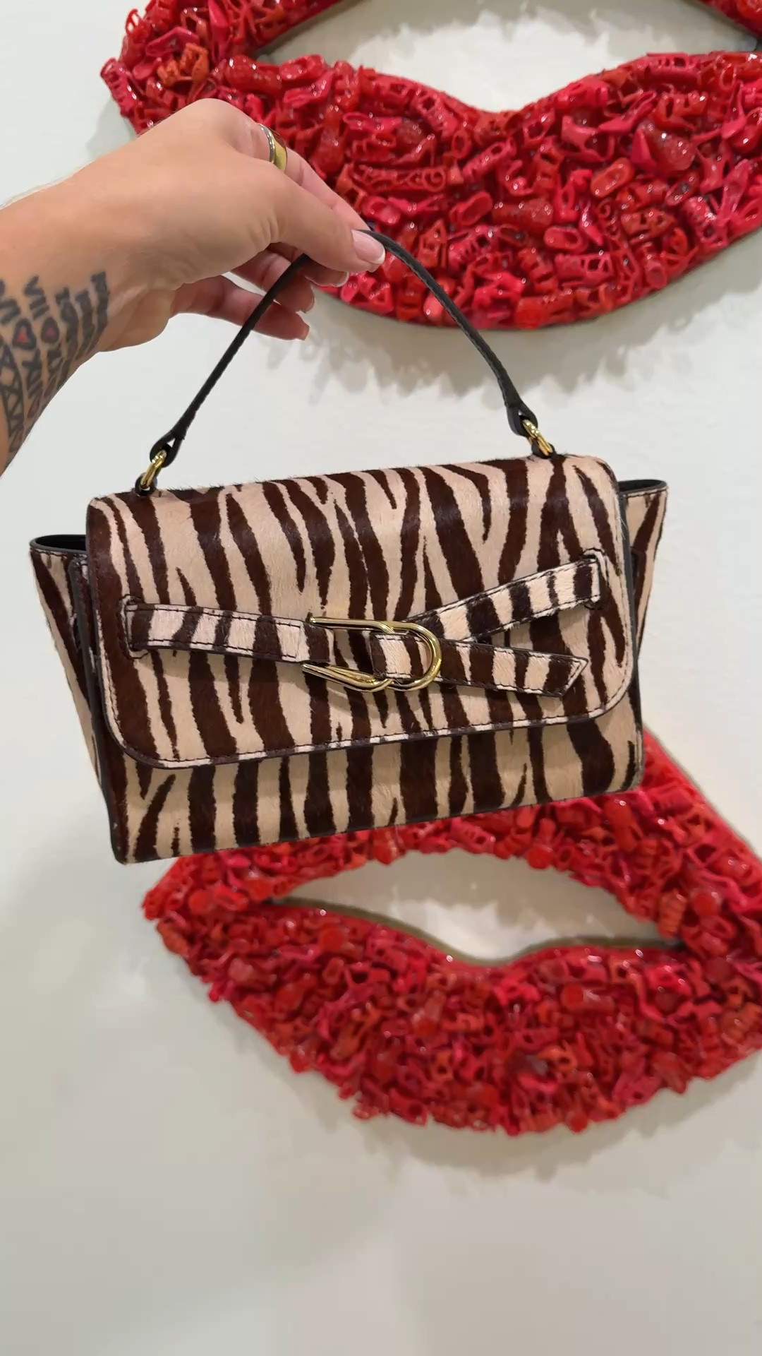 The bag that makes a neutral outfit stop being neutral.

Loeffler Randall's Alexi in cream zebra hair calf and brown leather is the crossbody I keep coming back to — the print is bold enough to be the moment but the brown leather trim keeps it grounded so it works with more than you'd think. Cream, tan, white, chocolate brown, even an all-black outfit where you want one thing to say something. This bag says it.

The hardware is belt-inspired with a sliding lock closure, which is the kind of detail that makes a $350 bag feel considered rather than just expensive. The removable crossbody strap means it converts to a top handle clutch when the occasion calls for it — two bags for the price of one is always a good argument.

Compact interior so pack light, but at this size it's the dinner and weekend bag, not the everything bag. 

 