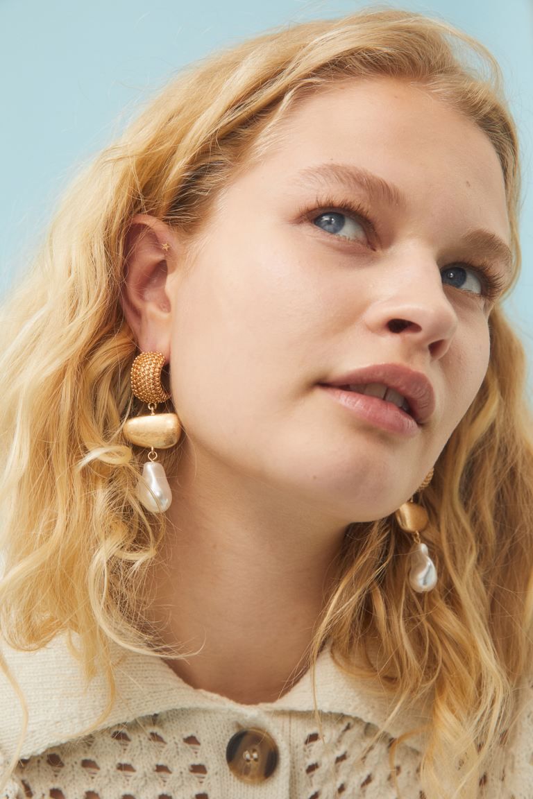 New ArrivalA pair of metal earrings with a textured top, oval-shaped pendants and pearly plastic ... | H&M (US + CA)