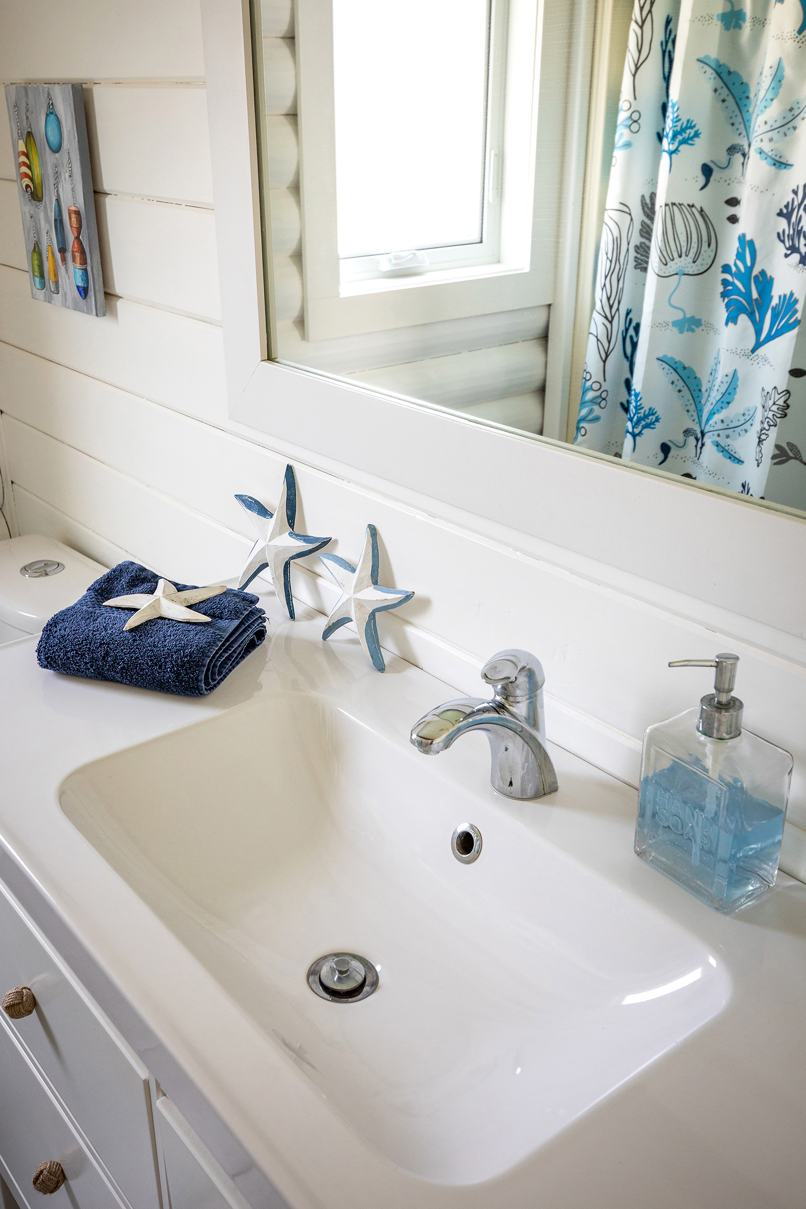 In my main floor bathroom, I have a larger Hemnes Vanity.  In keeping with my beach home, aka The Beach Chalet, I've personalized it with some sailor knot (or monkey fist) knobs.  This vanity has survived long term renters and airbnb guests and still looks new, after being installed in 2016.   

 #LTKhome