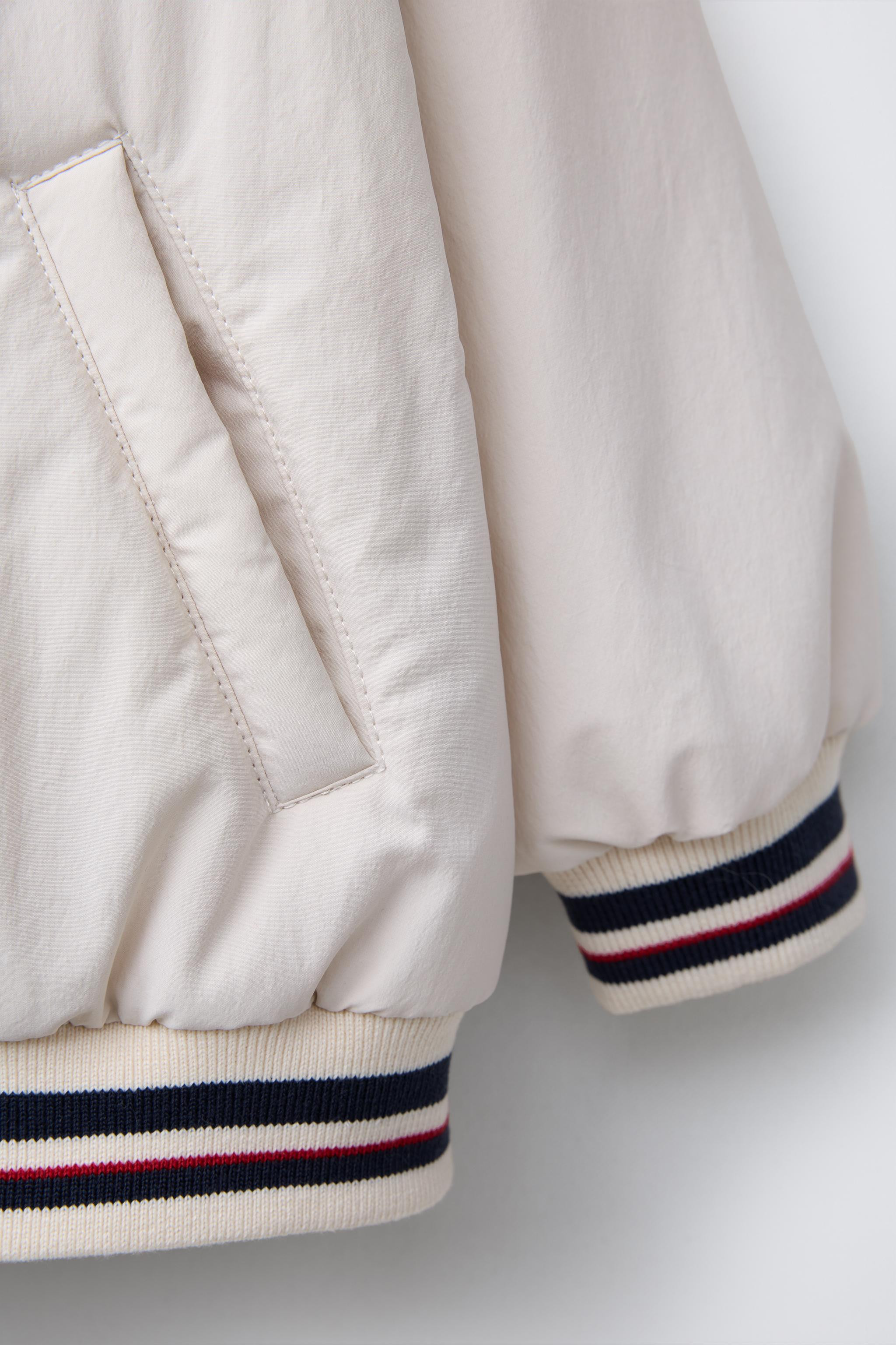 Varsity bomber jacket with stand-up collar and long sleeves with cuffs. Front snap-button closure... | Zara US