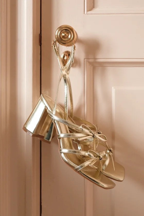 The radiant gold finish and elegant bow detail make these sandals perfect for resort dinners, destination weddings, and glamorous vacation evenings. Under $40.

Keywords:

* gold strappy heels
* bow heel sandals
* metallic high heels
* evening sandals
* wedding guest shoes
* statement heels
* dressy sandals
* elegant high heels
* bridal guest shoes
* cocktail party heels
* destination wedding shoes

#LTKootd #LTKTravel #LTKWedding