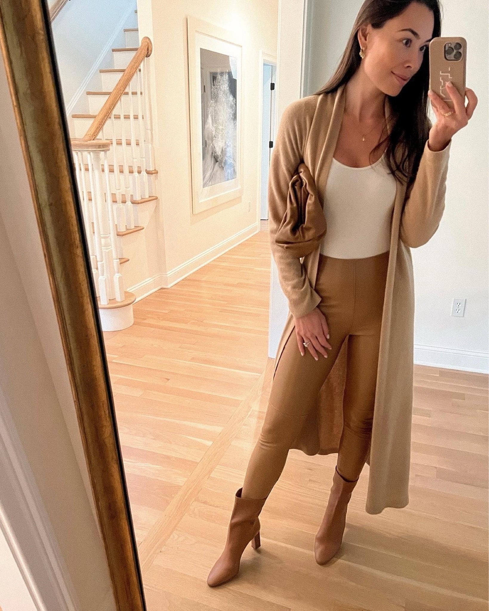 Kat Jamieson of With Love From Kat wears a camel sweater with leather leggings and brown booties. Fall style, neutral outfit. 

#LTKitbag #LTKshoecrush #LTKSeasonal
