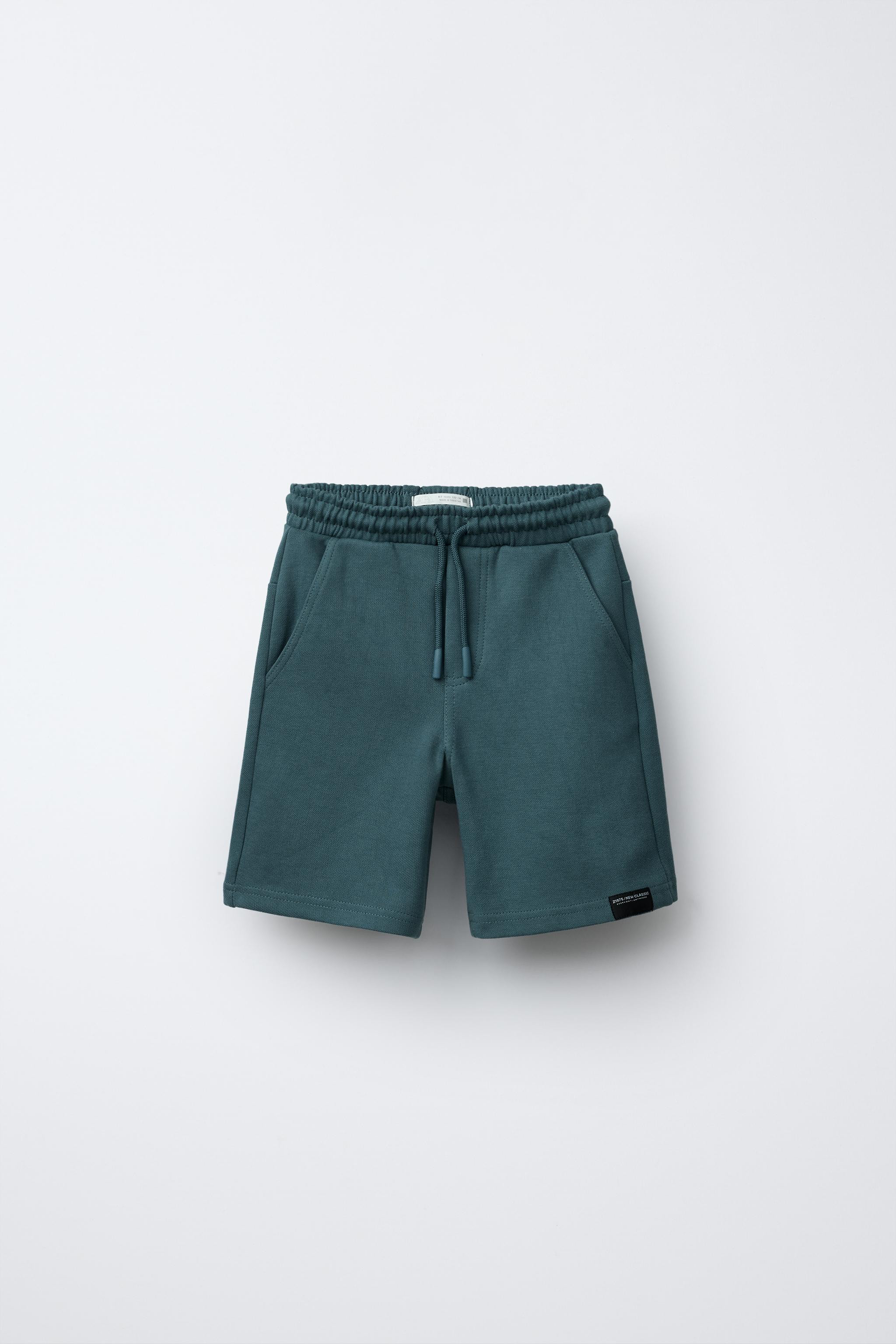 Bermuda shorts with elastic waistband and front drawstring appliqué. Front pockets and patch poc... | Zara US