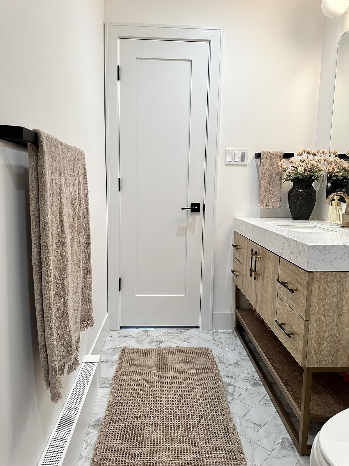 Bathroom refresh! Warm cozy bathroom. Viral waffle knit bath mat. Warm beige towels. Black artisan vase. Fluted foaming soap pump. Fluted glass candle. Tall linen shower curtain. Modern bathroom vanity. | Amazon (US)