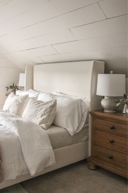 Neutral bedroom with upholstered bed frame, natural wood nightstands, and simple linens

#LTKhome