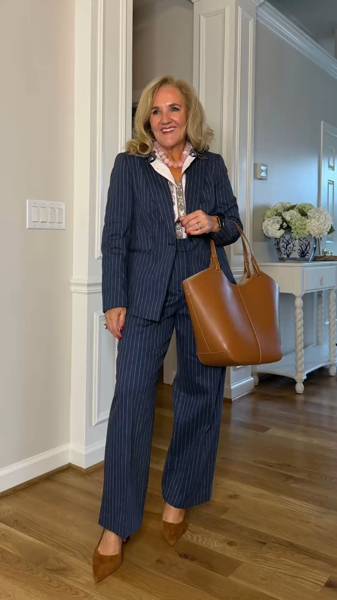 This navy pinstripe suit is polished, flattering, and surprisingly versatile. The wide-leg trousers and tailored blazer create an easy, sophisticated look, while the cognac tote and pointed-toe shoes add warmth.

💡 LTK MADE EASY
❤️ Heart = Support my posts!
🔖 Save = Get sale & restock alerts
📋 Lists = Keep favorites organized
📲 Share = Send lists and products to a friend. Hello, Christmas List!
💬 Comment = Ask me anything about what I'm wearing.:-)

#LTKdayinmylife #LTKgrwm #LTKootd