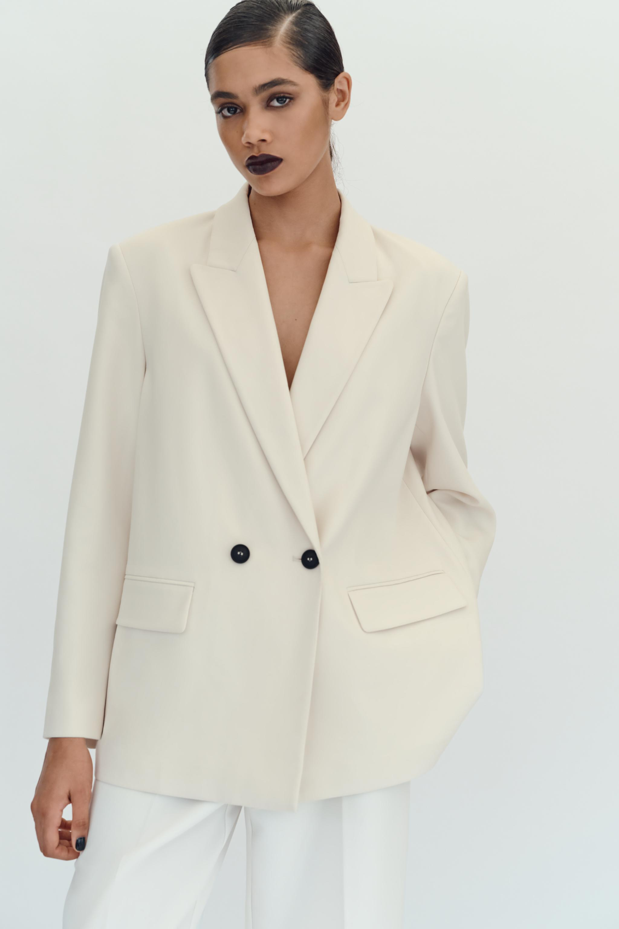 Full-cut blazer with lapel collar, long sleeves, and shoulder pads. Front flap pockets. Front dou... | Zara US