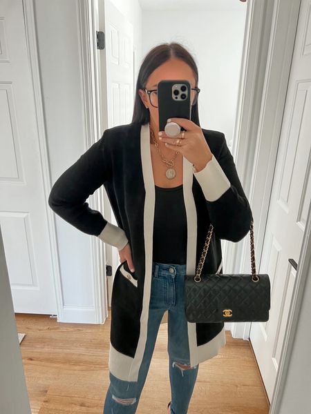Amazon Essentials black tank top wearing size medium. High Waisted Medium Wash Ripped Raw Hem Skinny Jeans wearing size 4. Tipped Padded Shoulder Novelty Button Pocket Cardigan waring size small. 

Follow my shop @thehouseofsequins on the @shop.LTK app to shop this post and get my exclusive app-only content!

#liketkit 
@shop.ltk
https://liketk.it/3ZDBu