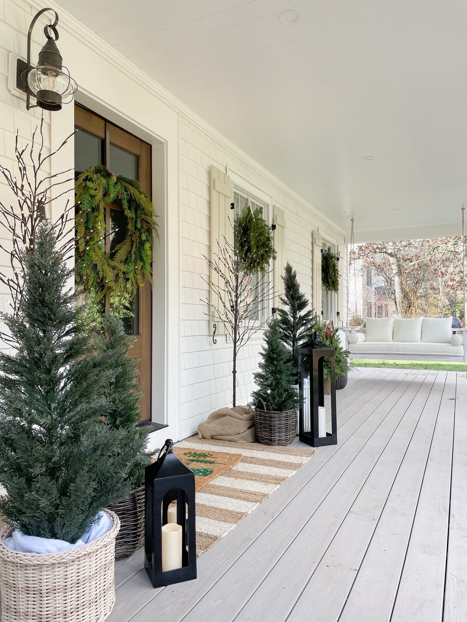Front porch decor, porch swing, faux trees, outdoor decor, lanterns, door mat, outdoor rug 

#LTKHome #LTKSeasonal #LTKHoliday