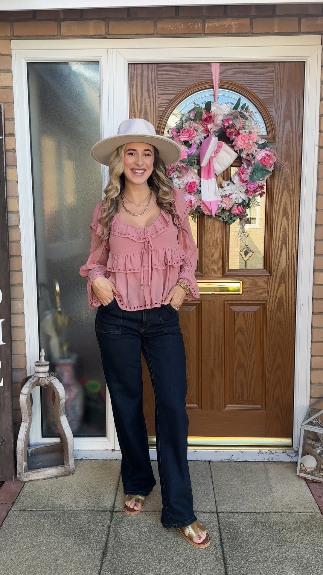 Fall Transition outfit. Fall style. Fall fashion. Wide brim hat. Mauve pink flouncy ruffle blouse. Dark wash bell bottom jeans. Gold sandals. 

#LTKSeasonal #LTKShoeCrush #LTKStyleTip