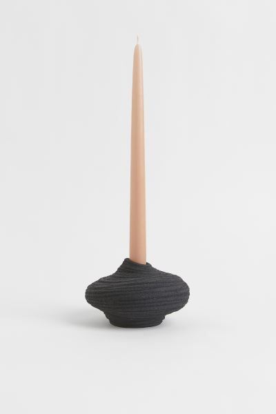 Asymmetric candlestick in stoneware with a textured finish. Height 3 1/4 in. Diameter at widest p... | H&M (US)