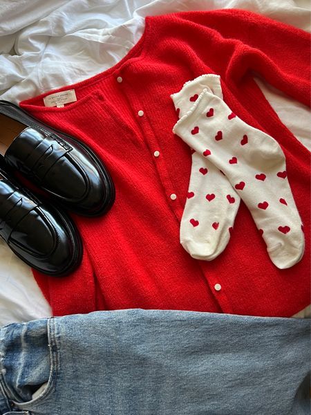 Valentine’s Day outfit flatly with loafers, heart socks, red cardigan, and light wash denim jeans 