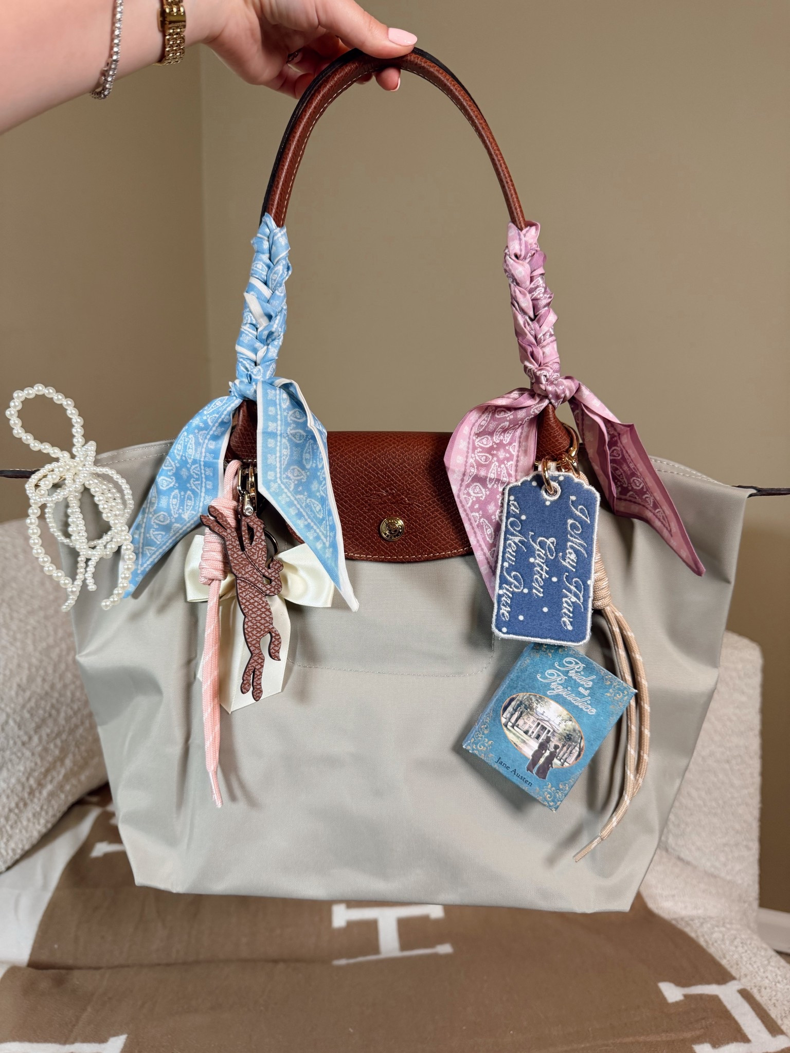 Bag of the day
Longchamp Le Pliage medium in the color pebble 
Twilly
Pride and prejudice mini book bag charm from Etsy
Etsy embroidered book charm tag
Corded bag charms from Amazon 
Pearl bow
Longchamp charm

