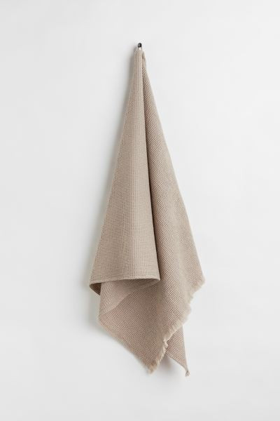 Conscious choice  Bath towel in waffled cotton fabric. Fringe at short sides and hanger loop on o... | H&M (US + CA)