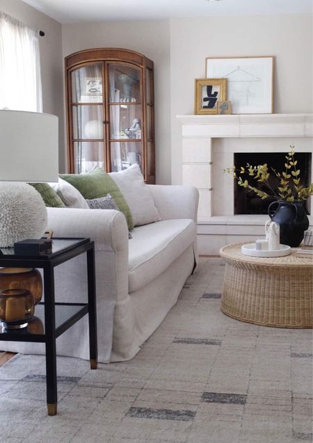 The living room decor has gone thru so many design changes, but this might be my favorite. Neutral color palette with vintage arched cabinets and round rattan coffee table. #vintagedecor #neutraldecor #eclectic 

#LTKsalealert #LTKover40 #LTKhome
