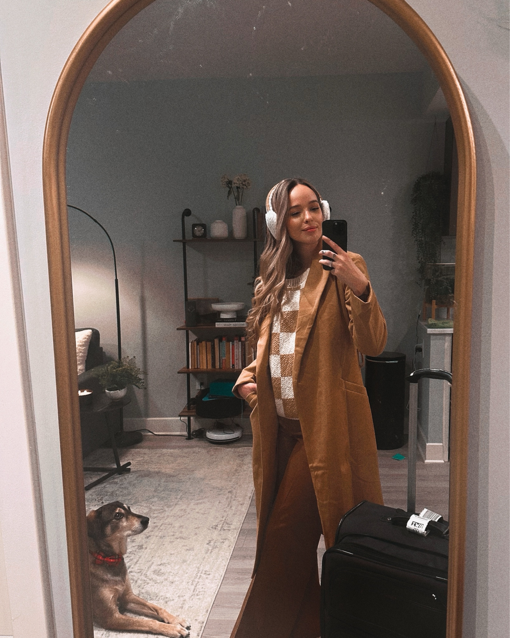 Probably one of my favorite cozy travel outfits to date. A warm and fuzzy checkerboard printed sweater vest, paired with a camel colored wide leg trouser. Topped with a lighter camel colored long top coat and a pointed toe boot to tie it all together. I’m also obsessing over these Ugg ear muffs this winter! 

#LTKWatchNow #LTKTravel #LTKSeasonal