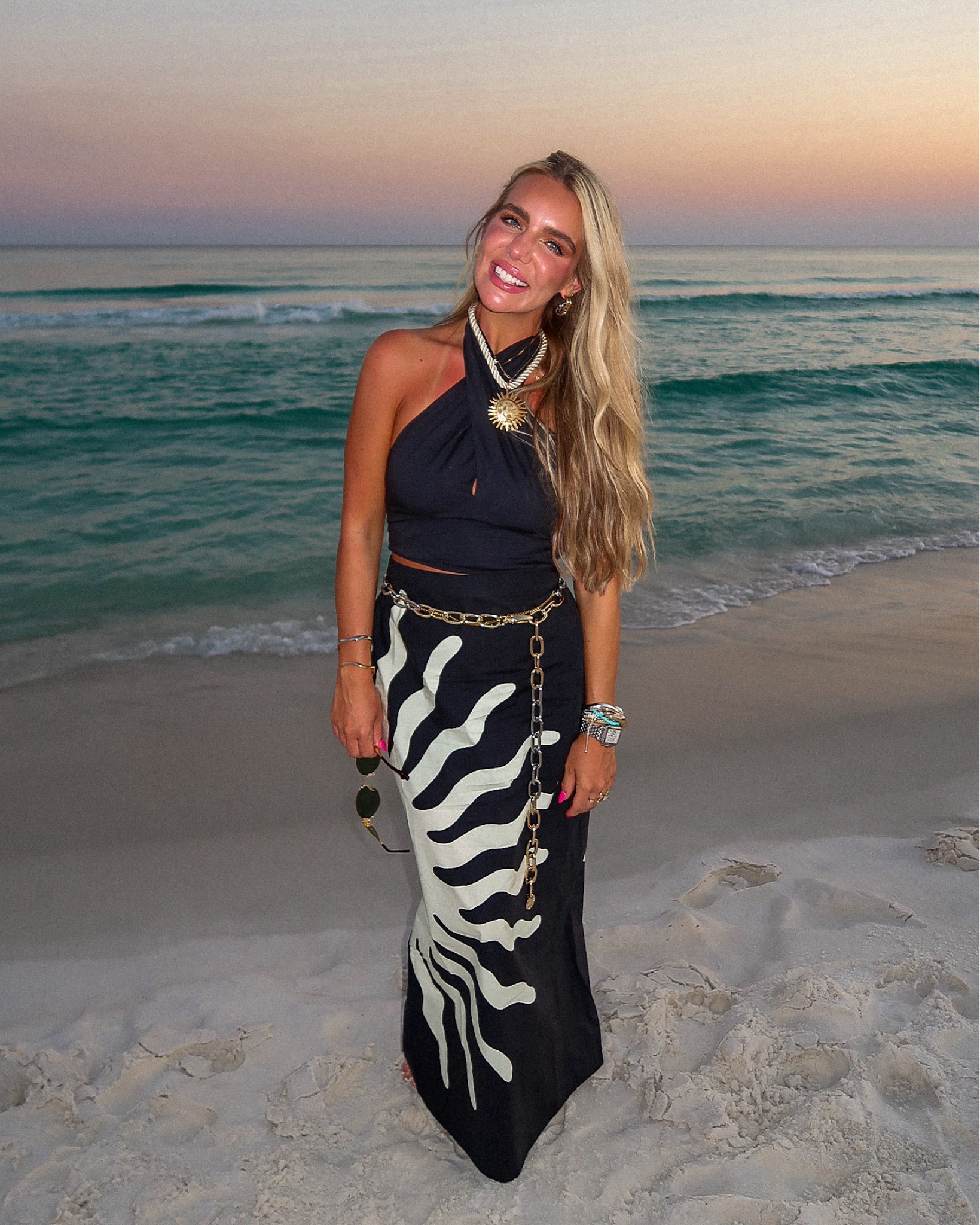 Pocket full of sunshine and sunset 🌞🌅 this black maxi sunshine ray pattern skirt was so fun for wedding guest outfit / dress for a beachside wedding in Seaside, FL. This sunshine necklace from Zara was the perfect icing on the cake. Paired with mixed metal belt and jewelry and my oldie but goodie Staud black poplin cross neck top. 

#LTKTravel #LTKWedding #LTKSwim