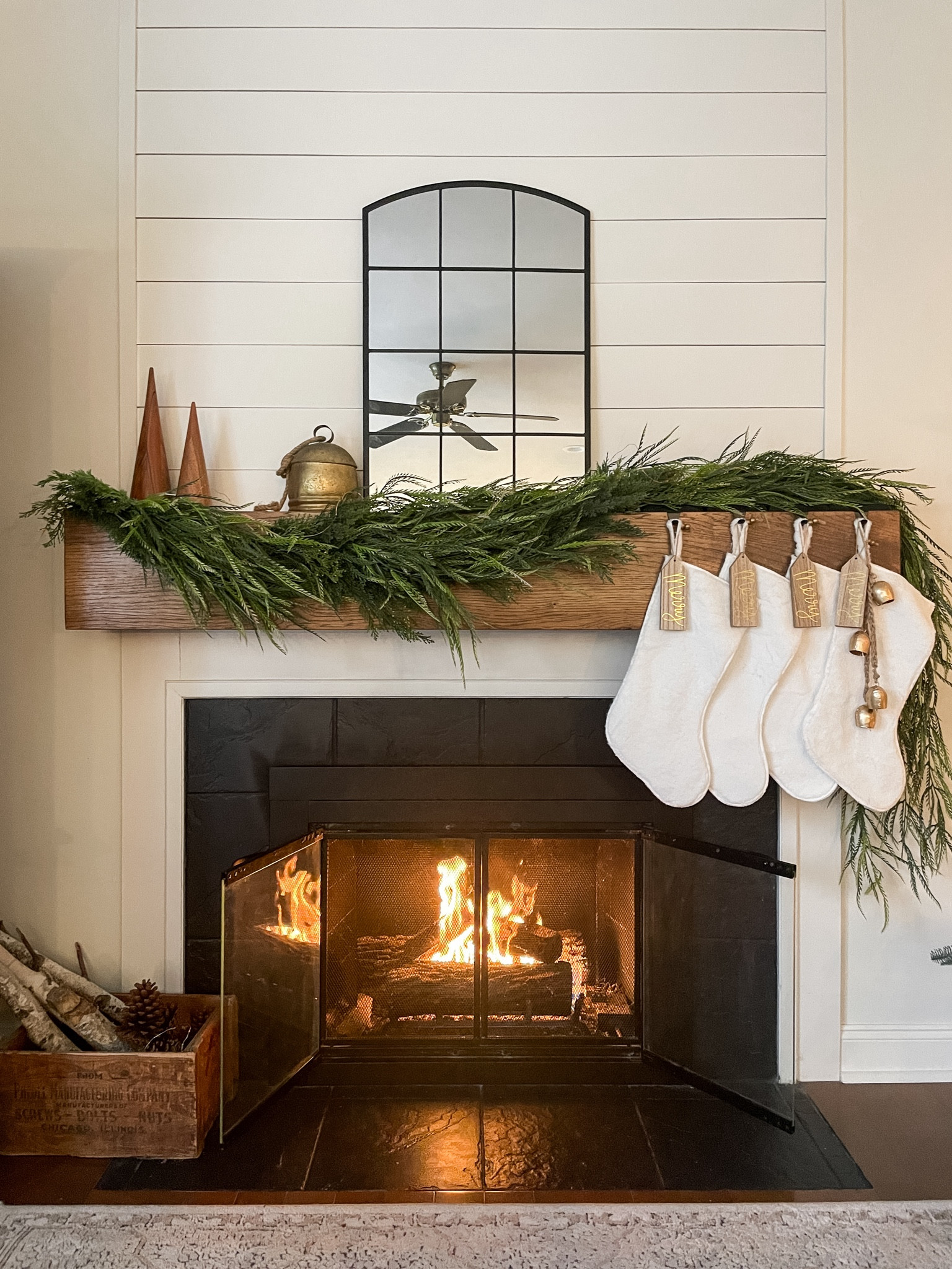 I love a full garland on my mantel with simple decor and neutral stockings.  

White faux fur stockings.  Vintage bell.  Wooden trees.  Fireplace mantel decor.  Christmas decor.  Arched black mirrors.  

#LTKHoliday #LTKSeasonal #LTKhome