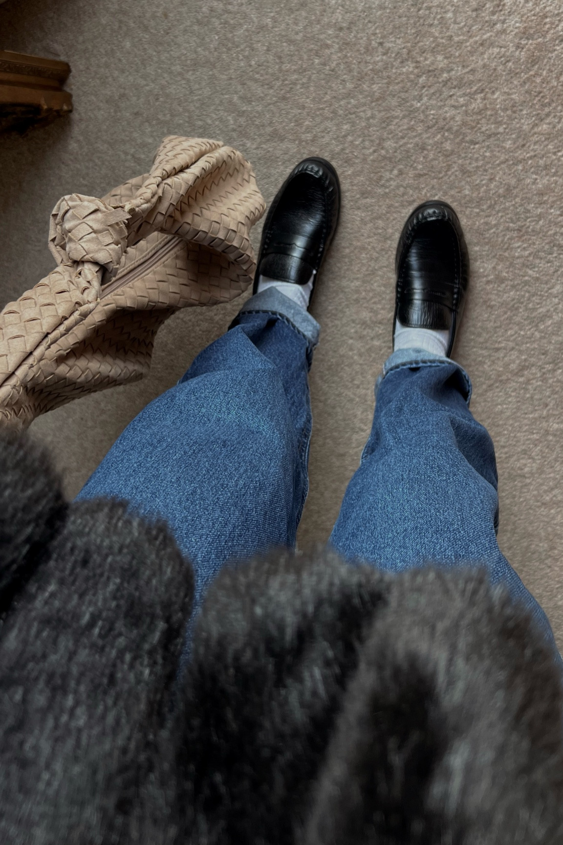 Winter outfit. Baggy tapered cuffed jeans. Dark denim. Black loafers. Relaxed loafers. Leather loafers. Woven shoulder bag. Faux fur jacket. European style. Weekend style. What to wear. How to wear. How to style. 

#LTKFindsUnder100 #LTKShoeCrush #LTKItBag