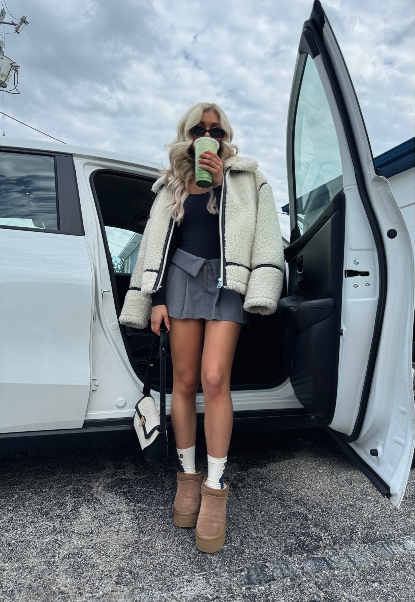 Winter fashion trends, fold over grey mini skirt, black long sleeve bodysuit, retro sunglasses, Ugg mini boots, Ralph Lauren polo bear socks, two toned hand bag, shoulder bag, Pinterest outfit, Sherpa biker jacket, leather coat, biker coat#LTKbeauty

#LTKHoliday #LTKSeasonal