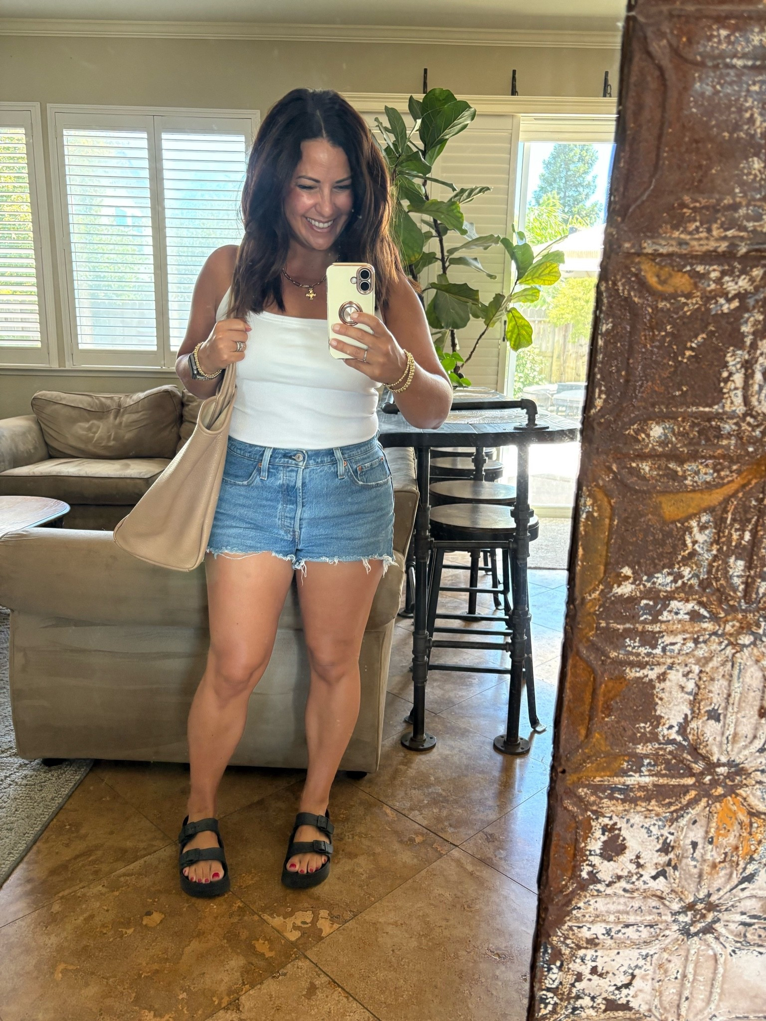 98° and this built-in bra tank is saving the day. ☀️

Running errands, chauffeuring kids, and trying to stay cool in my favorite built-in bra tank, denim shorts, comfy sandals, and everyday tote. One less thing to think about when it’s this hot. My ribbed tank is true to size, supportive and very comfortable, I’m wearing a small.

#LTKmomlife #LTKSeasonal #LTKOver40