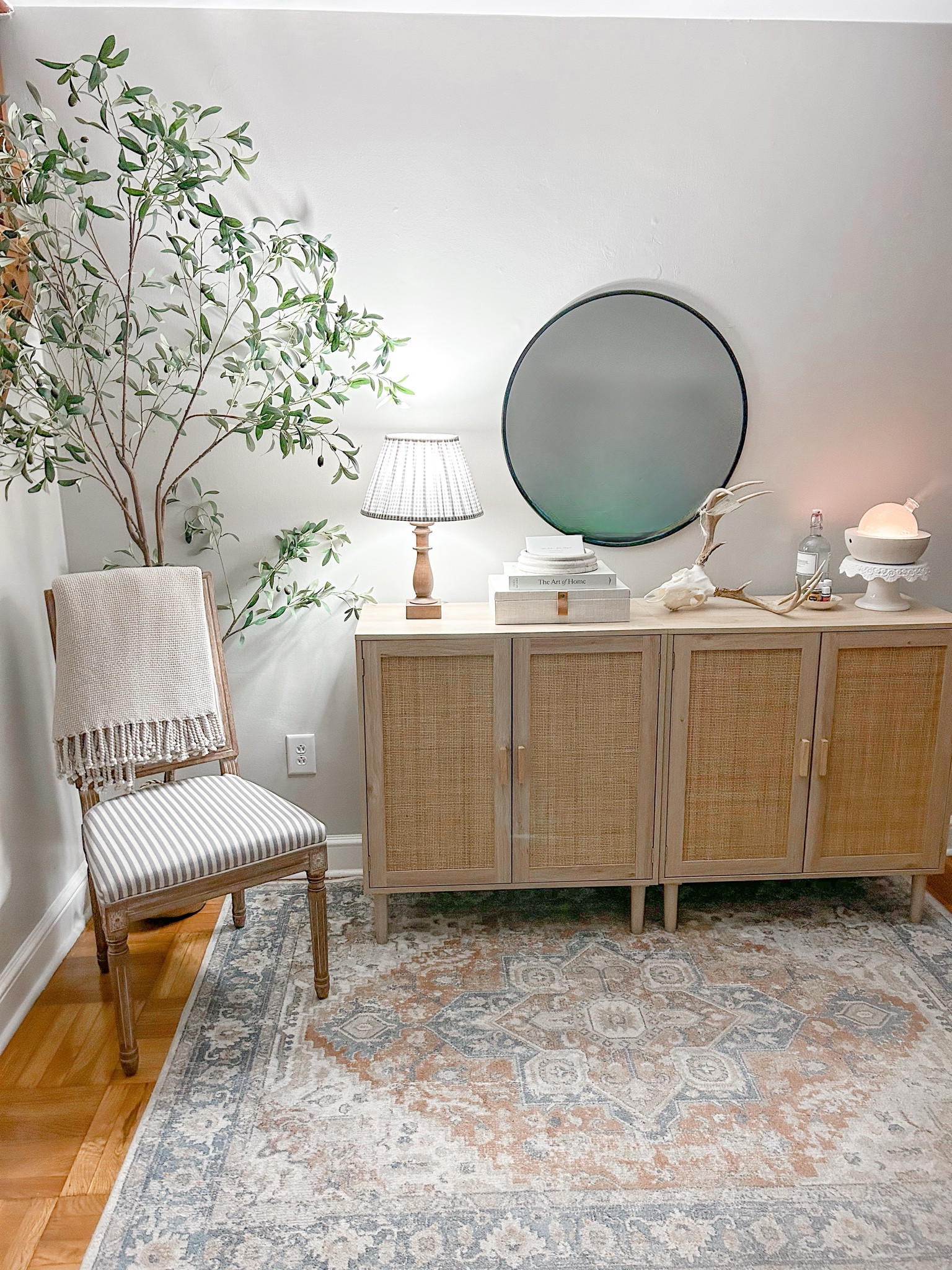 Entryway. Home. House. Target lamp. Gingham lamp shade. Brown wooden lamp base from target. Rattan cabinets from amazon. Thrifted rug and chair. Tall olive tree from amazon. Target round black mirror. Young living diffuser. Books. Interior design. Decor. Interior decorating. Love 

#LTKFindsUnder100 #LTKU #LTKHome